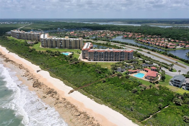 bird's eye view with a water view and a beach view