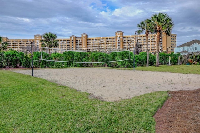 surrounding community featuring a lawn and volleyball court