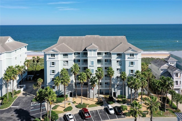 bird's eye view featuring a water view and a beach view