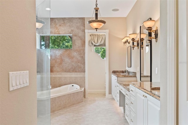 bathroom featuring tile patterned floors, vanity, toilet, and tiled tub