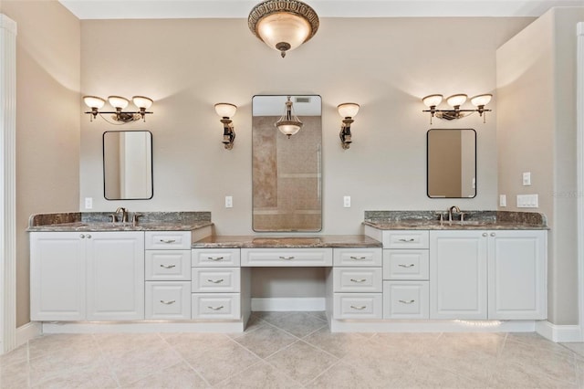 bathroom with tile patterned floors and vanity