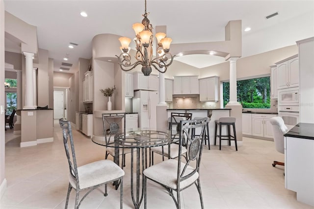 dining room with light tile patterned floors and an inviting chandelier