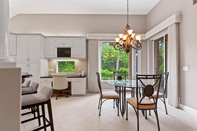 tiled dining room featuring vaulted ceiling and a notable chandelier