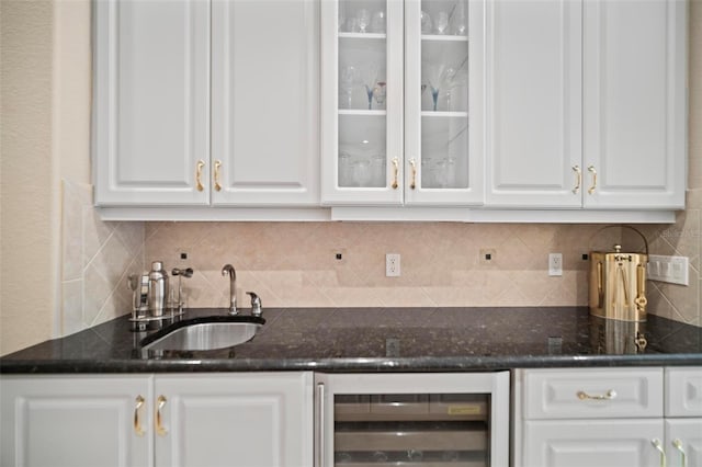 bar with white cabinetry, sink, wine cooler, dark stone countertops, and decorative backsplash