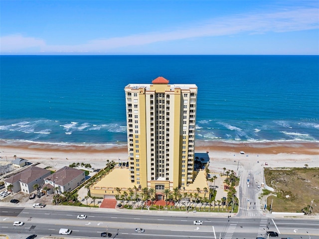 aerial view with a water view and a beach view