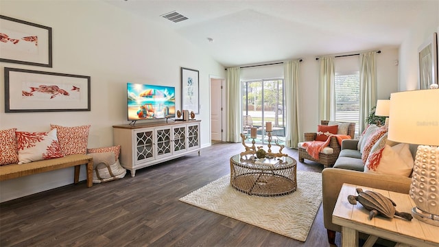 living room featuring dark hardwood / wood-style flooring and vaulted ceiling