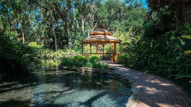 view of property's community with a gazebo and a water view