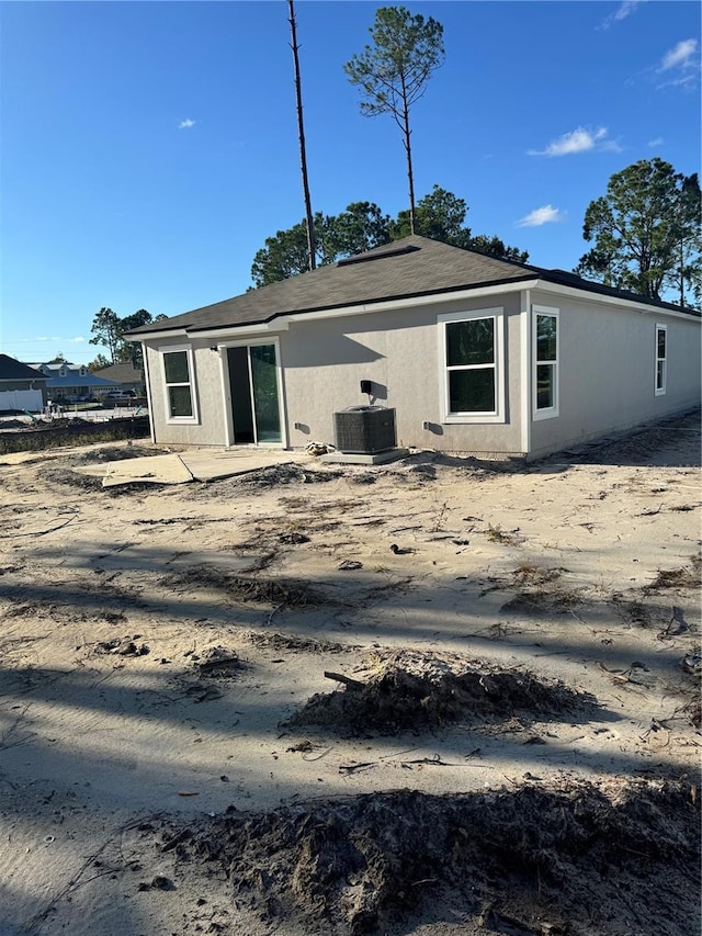 back of house featuring central AC unit