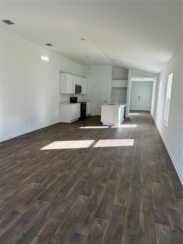 unfurnished living room featuring dark hardwood / wood-style flooring, sink, and vaulted ceiling