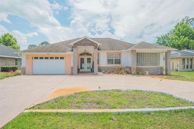 view of front of house with a garage, a front yard, and french doors