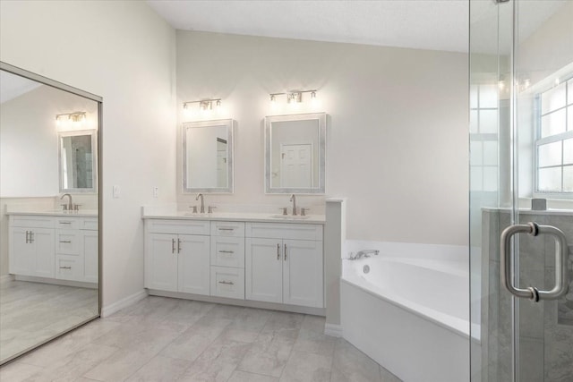 bathroom with vanity and independent shower and bath