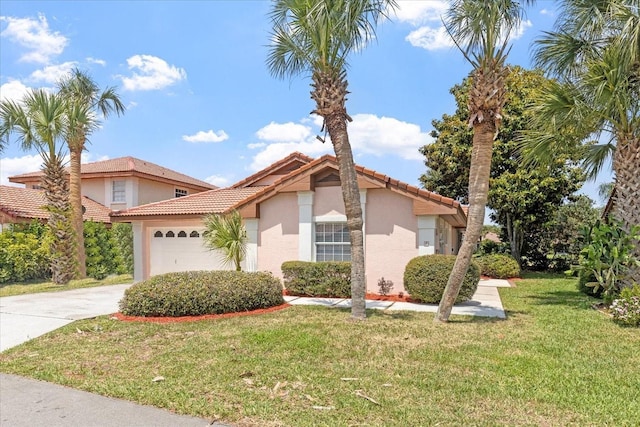 mediterranean / spanish-style house with a garage and a front lawn