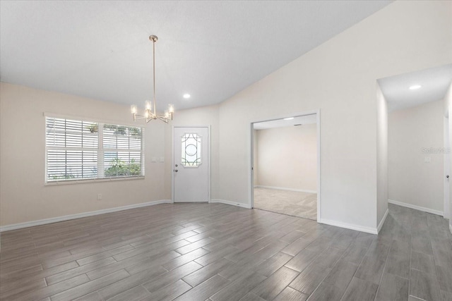 interior space with lofted ceiling, dark wood-type flooring, and a notable chandelier