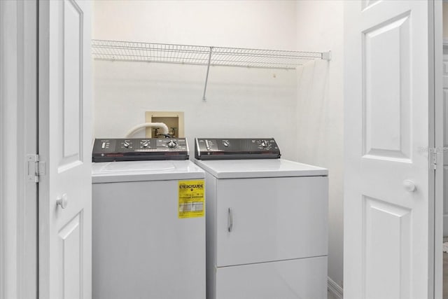 clothes washing area with washing machine and dryer