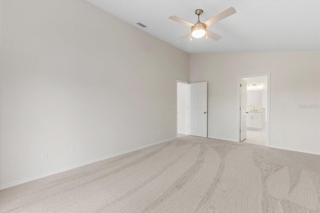 carpeted empty room featuring ceiling fan and vaulted ceiling