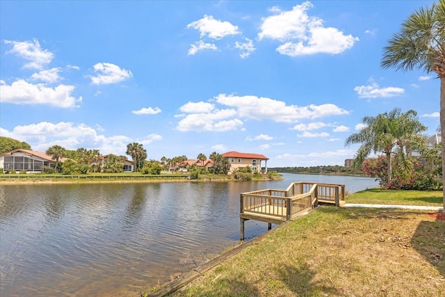 dock area with a yard and a water view