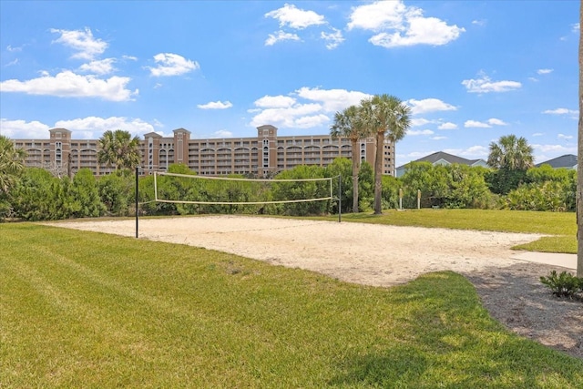 surrounding community featuring a yard and volleyball court