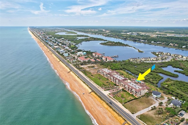 bird's eye view with a water view and a beach view