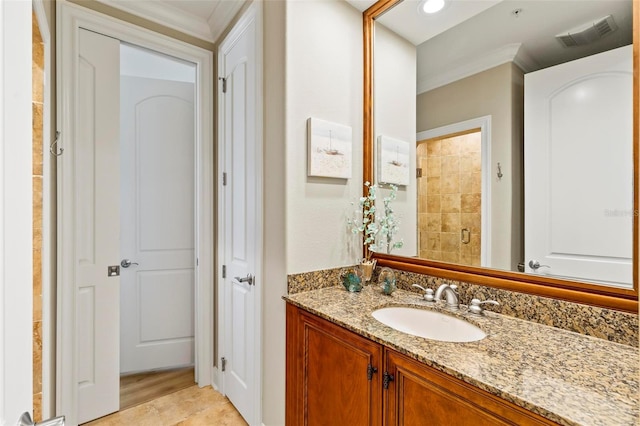 bathroom with vanity, wood-type flooring, ornamental molding, and a shower with door