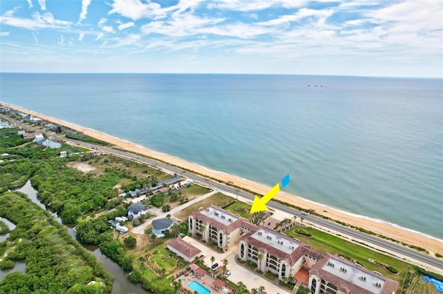 drone / aerial view with a water view and a view of the beach