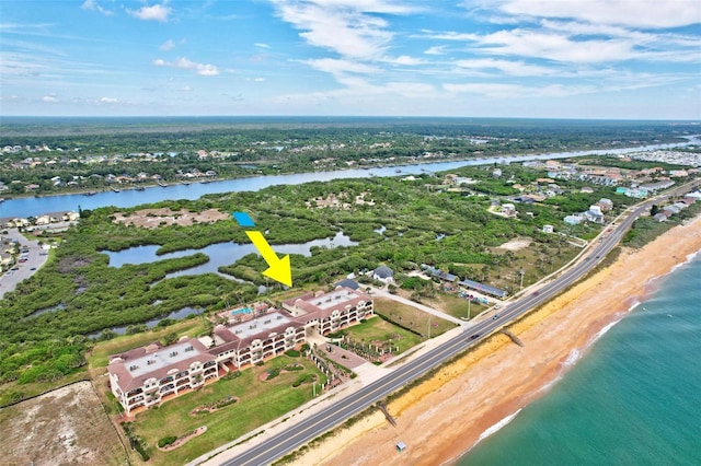 drone / aerial view featuring a water view and a view of the beach