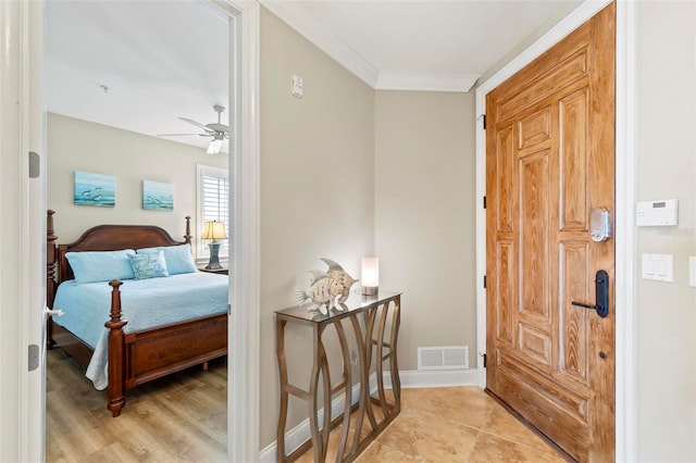 interior space with ceiling fan, crown molding, and light wood-type flooring