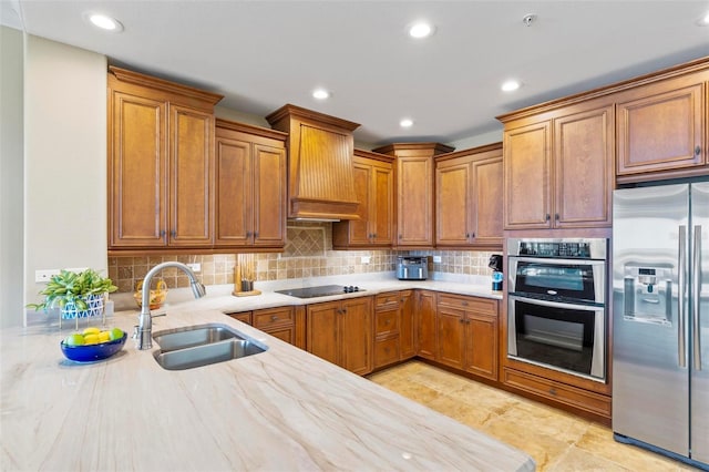 kitchen featuring backsplash, stainless steel appliances, premium range hood, and sink