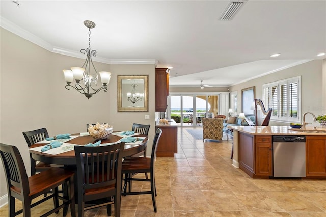 dining space featuring ornamental molding, ceiling fan with notable chandelier, a healthy amount of sunlight, and sink