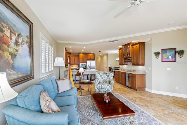 tiled living room featuring ceiling fan, ornamental molding, and wine cooler