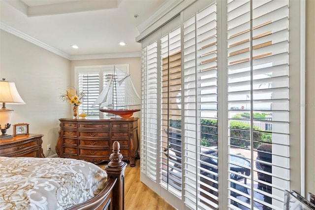 bedroom with light hardwood / wood-style floors and ornamental molding