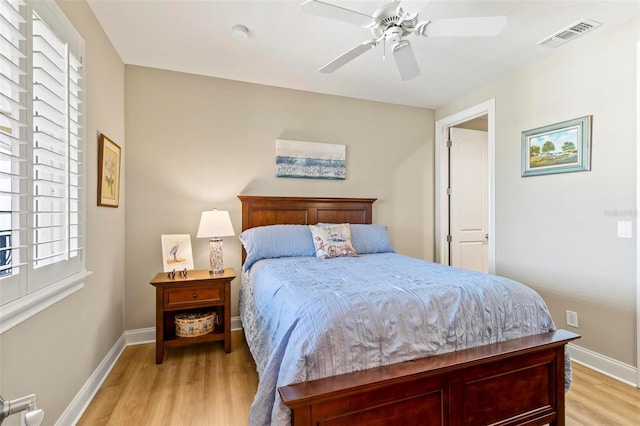 bedroom with ceiling fan, light wood-type flooring, and multiple windows