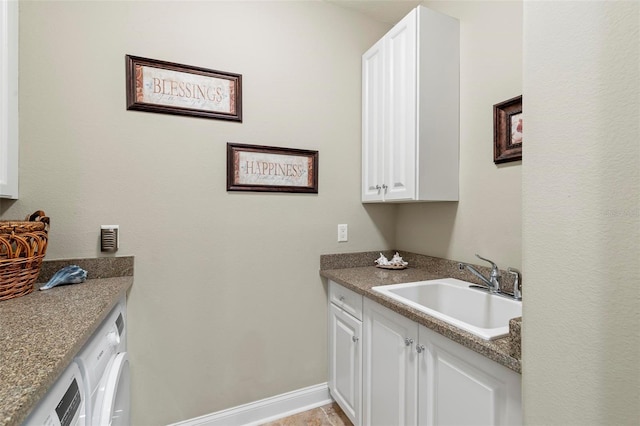 washroom with washing machine and dryer, sink, light tile patterned floors, and cabinets