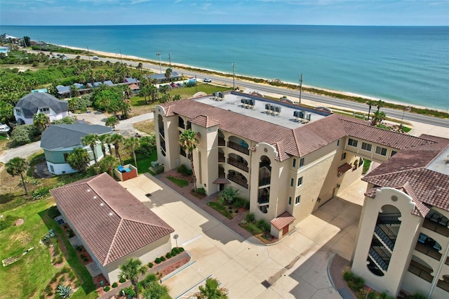 birds eye view of property with a view of the beach and a water view