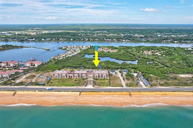 drone / aerial view featuring a view of the beach and a water view