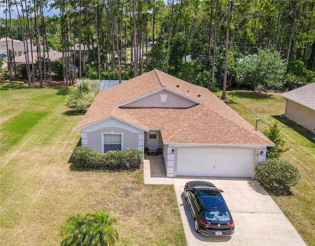 view of front of property with a front yard and a garage