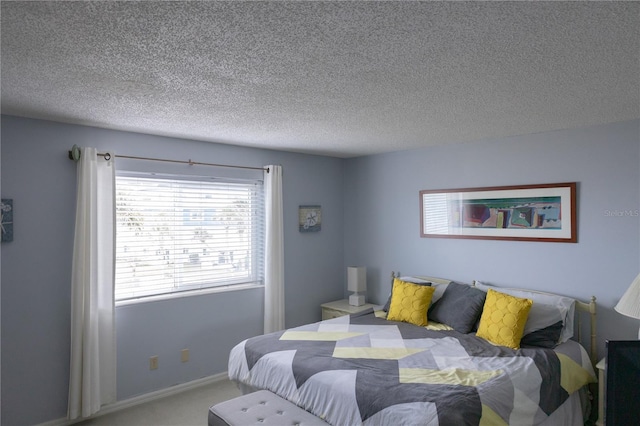 carpeted bedroom with a textured ceiling