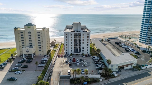 drone / aerial view featuring a water view and a beach view