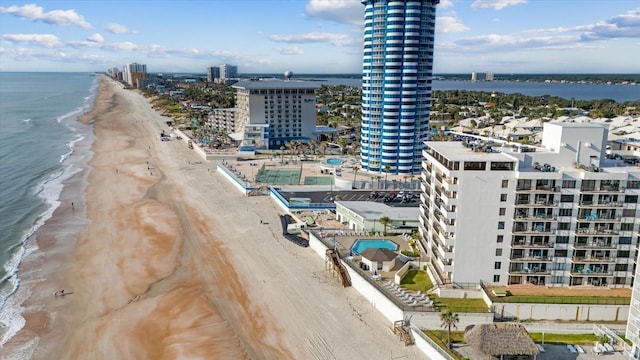 bird's eye view with a water view and a beach view