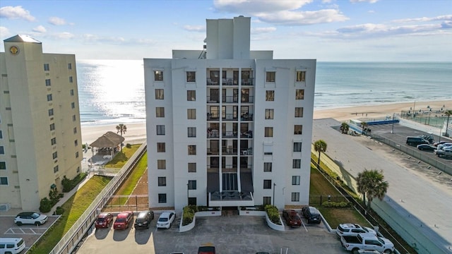 view of property with a view of the beach and a water view