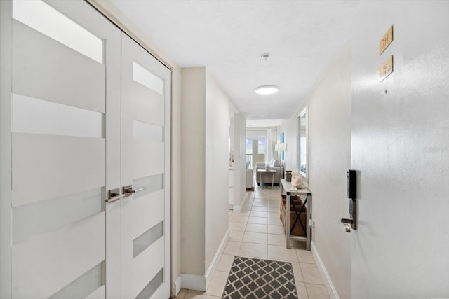 corridor featuring light tile patterned flooring