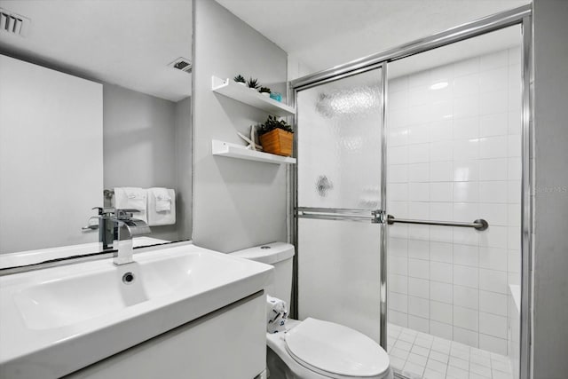 bathroom with vanity, toilet, and a shower with shower door