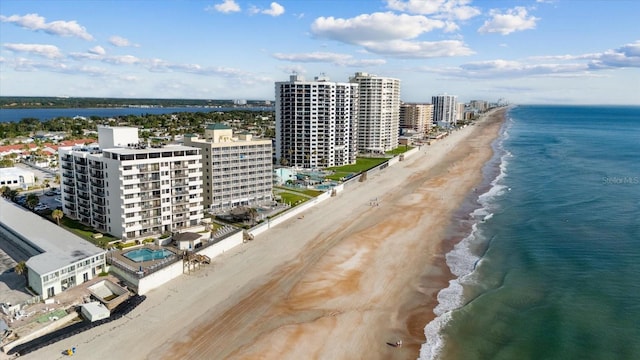 drone / aerial view featuring a beach view and a water view