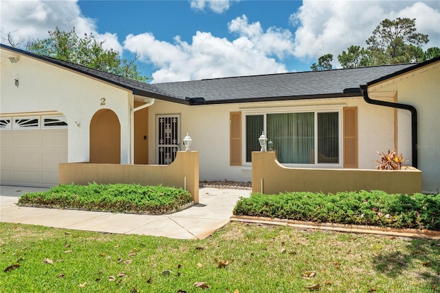 ranch-style home with a front yard and a garage