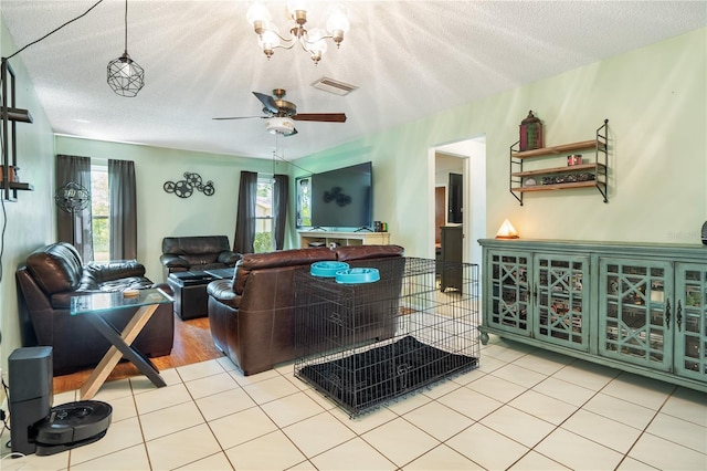 tiled living room featuring ceiling fan and a textured ceiling