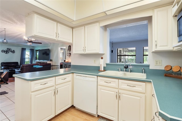 kitchen with ceiling fan, dishwasher, kitchen peninsula, a wealth of natural light, and sink