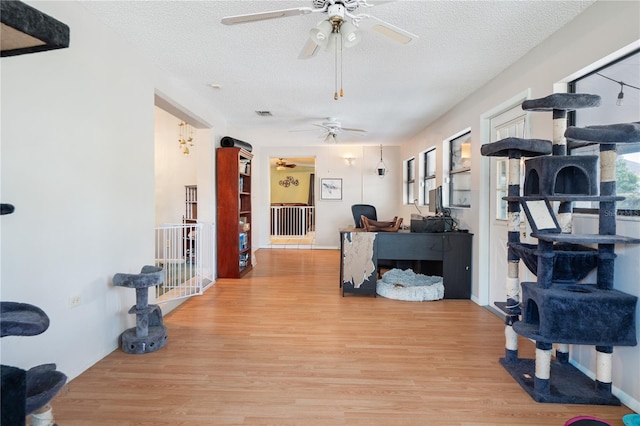 interior space featuring a textured ceiling and light hardwood / wood-style floors