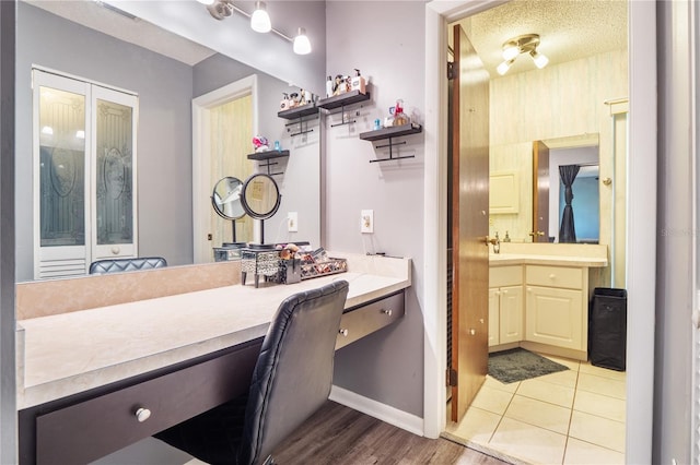 bathroom featuring a textured ceiling, tile patterned floors, and vanity