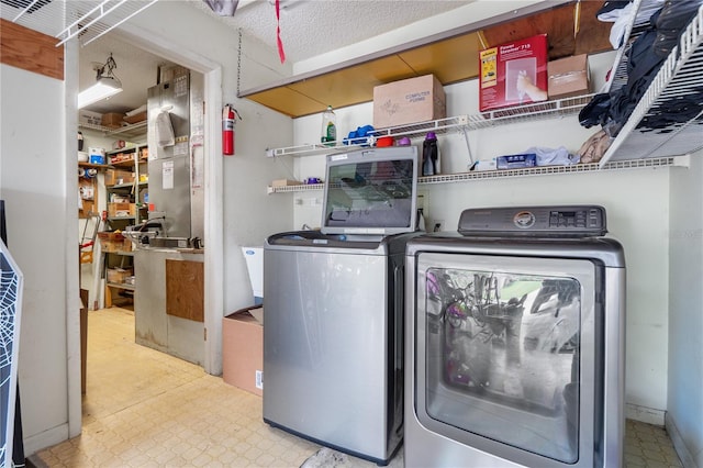 washroom featuring washer and clothes dryer