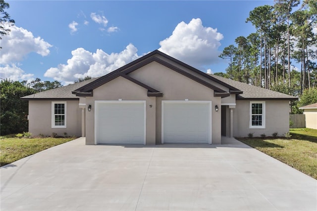 single story home with a garage and a front yard