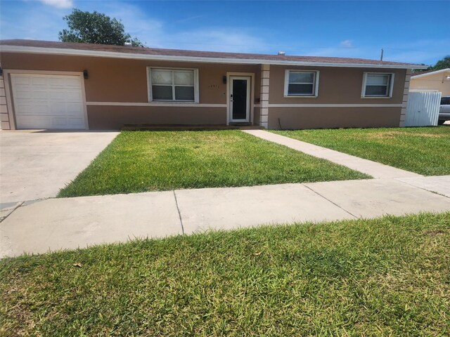 10611 SW 164th St, Miami, FL 33157 - ranch-style home featuring stucco siding, a front lawn, an attached garage, and concrete driveway